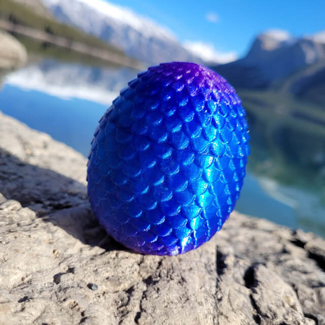 Twilight dragon egg sitting on a rock by the lake